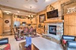 Living room offers a murphy bed located next to fireplace and TV